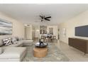 Bright living room featuring a comfortable sofa, ceiling fan, and an open layout perfect for entertaining at 2130 W Colter St, Phoenix, AZ 85015