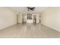 Open-concept living room with tile flooring leading to a breakfast bar and kitchen area at 2130 W Colter St, Phoenix, AZ 85015