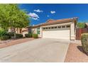 Inviting home with a clean driveway, manicured bushes, and a convenient two-car garage at 29161 N Lilly Ln, San Tan Valley, AZ 85143