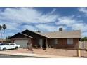 Lovely single-story brick home with a well-kept lawn and inviting curb appeal at 3106 E Grove Ave, Mesa, AZ 85204