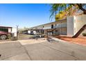 Apartment complex with gated entrance and lush landscaping on a sunny day at 3314 N 68Th St # W112, Scottsdale, AZ 85251