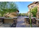 Private courtyard with stone pillars, lush greenery and desert views offers a tranquil retreat at 35443 N 87Th Pl, Scottsdale, AZ 85266
