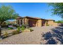 Spacious three-car garage with beautiful wood doors and paver driveway, perfect for car enthusiasts at 35443 N 87Th Pl, Scottsdale, AZ 85266
