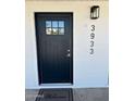 The front door is a dark color that complements the white brick exterior at 3933 E Flower St, Phoenix, AZ 85018