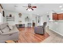 Spacious living room featuring wood floors, a ceiling fan, and comfortable seating at 4323 S Ranger Trl, Gilbert, AZ 85297