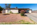 Quaint single-story home with desert landscaping and a covered front patio at 4403 N 56Th Dr, Phoenix, AZ 85031