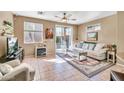 Bright living room with sliding glass doors, tile flooring, and neutral decor at 450 W Mountain Sage Dr, Phoenix, AZ 85045
