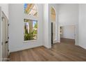 Bright living room boasts soaring ceilings, lots of natural light, and wood-look floors at 5520 E Muriel Dr, Scottsdale, AZ 85254