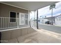 Spacious covered porch featuring white railings, offering shade and outdoor enjoyment at 591 S Ironstone Dr, Apache Junction, AZ 85119