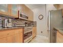 Modern kitchen equipped with stainless steel appliances, custom cabinetry, and granite countertops for a sleek and functional space at 6900 E Princess Dr # 1176, Phoenix, AZ 85054
