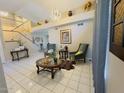 Bright living room with neutral walls, tile flooring, and modern decor at 8742 W Edgemont Ave, Phoenix, AZ 85037