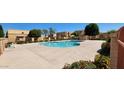 Community pool area surrounded by desert landscaping and several apartment buildings at 948 S Alma School Rd # 71, Mesa, AZ 85210