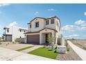 Beautiful two-story home featuring a front yard with brick pavers, fresh grass, and modern design elements at 10241 E Ursula Ave, Mesa, AZ 85212