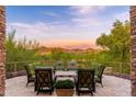 Charming outdoor patio with comfortable seating and scenic golf course views, perfect for enjoying the beautiful desert landscape at 10267 E Cinder Cone Trl, Scottsdale, AZ 85262