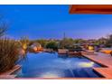Resort-style pool area with integrated spa, desert landscaping, and elegant lighting, creating a serene outdoor oasis at 10267 E Cinder Cone Trl, Scottsdale, AZ 85262