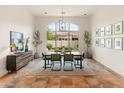 Dining room with large windows, natural light, table, and seating at 11490 E Beck Ln, Scottsdale, AZ 85255