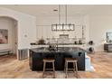 Beautiful kitchen with an island, stone countertops, and wooden stools at 11490 E Beck Ln, Scottsdale, AZ 85255