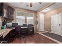 Home office featuring rich dark wood flooring, desk, and white painted door at 12226 W Planada Ln, Sun City, AZ 85373