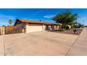 Attractive home featuring a driveway, a two-car garage, and a desert-landscaped front yard at 12241 N 49Th Ave, Glendale, AZ 85304