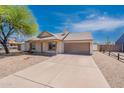 Cozy single-story house boasts a spacious driveway, two-car garage, xeriscape front yard, and a charming front porch at 12613 N 51St Dr, Glendale, AZ 85304