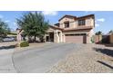 Charming two-story home with a well-manicured front yard and a two car garage at 15241 W Madison St, Goodyear, AZ 85338