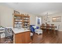 A spacious living and dining room with dark wood floors and cozy furniture arrangement at 15241 W Madison St, Goodyear, AZ 85338
