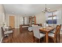 Inviting living room with a dark wood floors, a dining table and ample natural light at 15241 W Madison St, Goodyear, AZ 85338