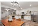 Open kitchen featuring white cabinetry, stainless steel appliances, and granite countertops at 15488 W Aster Dr, Surprise, AZ 85379