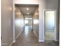 Long hallway with tile flooring provides a bright, open feel leading to other rooms at 17505 W Fulton St, Goodyear, AZ 85338