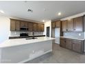 Modern kitchen with quartz countertops, stainless appliances, and ample cabinet space at 17505 W Fulton St, Goodyear, AZ 85338