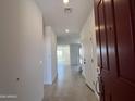 Bright entryway featuring tiled floors and leading into the home's open layout at 17511 W Fulton St, Goodyear, AZ 85338