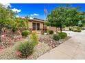 Charming single-story home with desert landscaping, an American flag, and a cozy, inviting curb appeal at 18495 W Rimrock St, Surprise, AZ 85388