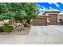 Home with a large three-car garage and a well-maintained driveway for easy access and parking at 18495 W Rimrock St, Surprise, AZ 85388