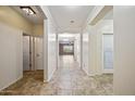 Inviting hallway leading to the living area, laundry and bedroom, with neutral tones and tile flooring at 18495 W Rimrock St, Surprise, AZ 85388