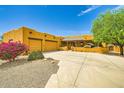 Beautiful home with a two-car garage, desert landscaping, and a welcoming facade at 19834 W Minnezona Ave, Litchfield Park, AZ 85340