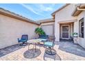 Cozy outdoor seating area on a paved patio, sheltered beneath the roof's eaves at 20215 N Mariposa Way, Surprise, AZ 85374