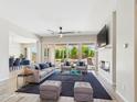 Inviting living room featuring stylish furniture, a cozy fireplace, and large sliding doors to the backyard at 20615 W Daniel Pl, Buckeye, AZ 85396