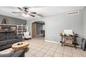 Open-concept living room with tile floors, built-in shelves, and a decorative stone fireplace at 2064 W 2Nd St, Mesa, AZ 85201