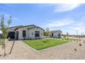 Charming home with a perfectly manicured lawn and attractive landscaping, creating a welcoming and inviting entrance at 2087 N 77Th Pl, Mesa, AZ 85207