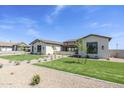 Beautiful home with a lush green lawn and manicured landscaping, offering a welcoming exterior at 2087 N 77Th Pl, Mesa, AZ 85207