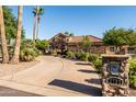 Beautiful stone home with tile roof, lush landscaping, and a charming mailbox at the front at 2107 E Park Ave, Gilbert, AZ 85234