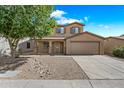 Inviting two-story home with low-maintenance front yard, desert landscaping, and a spacious two-car garage at 2327 E Meadow Creek Way, San Tan Valley, AZ 85140