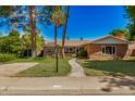 Charming brick home features a tile roof, green lawn, mature trees, and inviting walkway at 28 E 14Th St, Tempe, AZ 85281