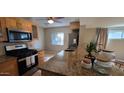 Modern kitchen with stainless steel appliances and a granite countertop at 3526 E Piccadilly Rd, Phoenix, AZ 85018
