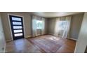 Bright living room featuring hardwood floors, light neutral walls, and large windows at 3526 E Piccadilly Rd, Phoenix, AZ 85018