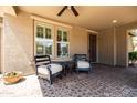 Inviting covered patio with comfortable seating and a view of the landscaped backyard at 3664 E Narrowleaf Dr, Gilbert, AZ 85298