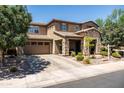 Attractive two-story home with stone accents, desert landscaping, and a spacious driveway leading to the garage at 3664 E Narrowleaf Dr, Gilbert, AZ 85298