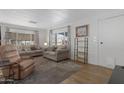 Comfortable living room with laminate floors, updated paint, and plenty of natural light at 4065 E University Dr # 332, Mesa, AZ 85205
