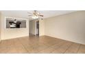 Bright and airy living room featuring neutral walls, tile flooring, and a ceiling fan at 4219 W Pasadena Ave, Phoenix, AZ 85019