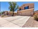 Two-story home with large concrete driveway and desert landscaping at 4702 N 124Th Ave, Avondale, AZ 85392